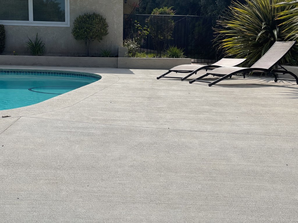 Concrete pool deck around a backyard pool in Stockton